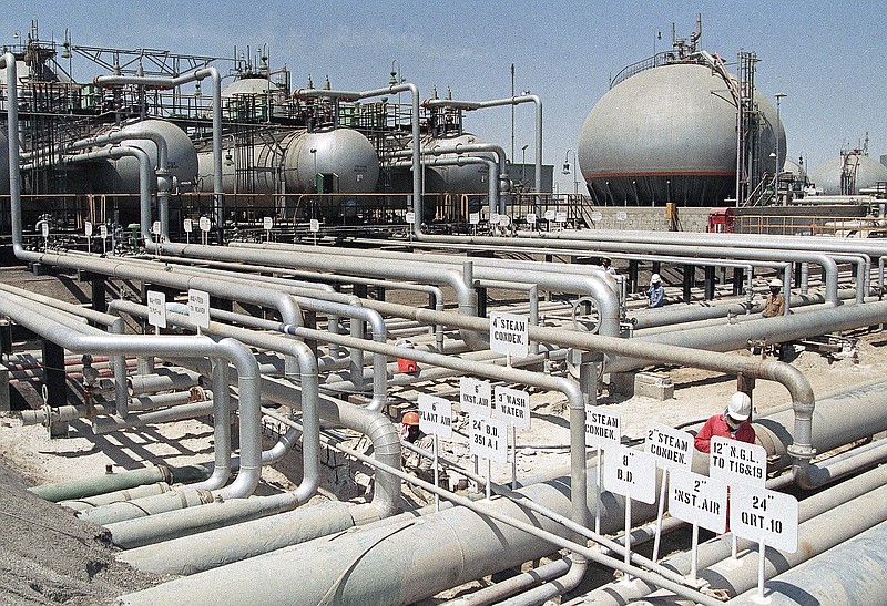 FILE - In this file photo dated 1990, Aramco refinery at Ras Tannura, Saudi Arabia. The price of oil surged Friday Jan. 3, 2020, as global investors were gripped with uncertainty over the potential repercussions and any retaliation, after the United States killed Iran's top general Qassem Soleimani.(AP Photo/FILE)