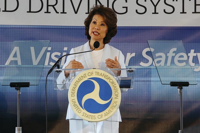 FILE - In this Sept. 12, 2017 file photo, U.S. Transportation Secretary Elaine Chao announces new voluntary safety guidelines for self-driving cars during a visit to an autonomous vehicle testing facility at the University of Michigan, in Ann Arbor, Mich. The Trump administration announced its most recent round of guidelines for autonomous vehicle makers, continuing to rely on the industry to police itself despite calls for specific regulations. Chao announced the proposed guidelines in a speech Wednesday, Jan. 8, 2020 at the CES gadget show in Las Vegas, saying in prepared remarks that "AV 4.0" will ensure U.S. leadership in developing new technologies.(Hunter Dyke/The Ann Arbor News via AP, File)