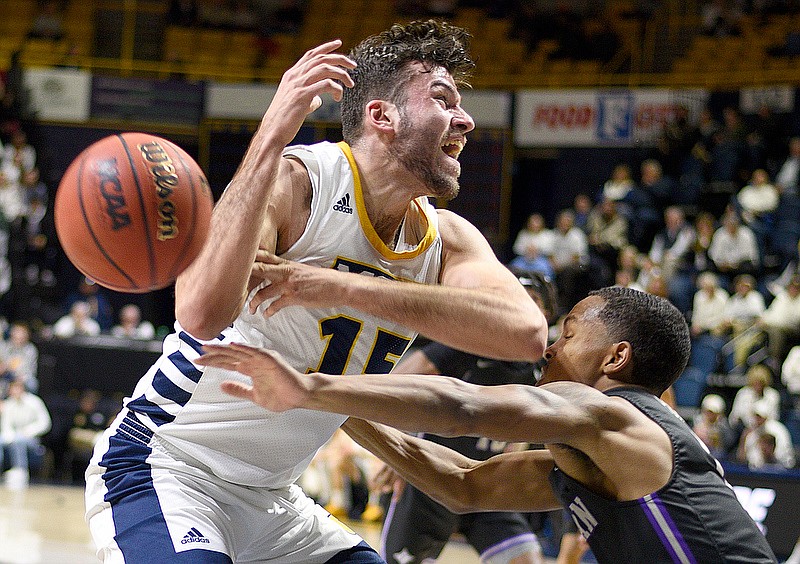 Staff Photo by Robin Rudd/  Furman's Jaylon Pugh (1) knocks the ball away from UTC's Ramon Villa (15).  The University of Tennessee at Chattanooga Mocs hosted the Furman University Paladins in Mens Southern Conference Basketball at McKenzie Arena on January 8, 2020.