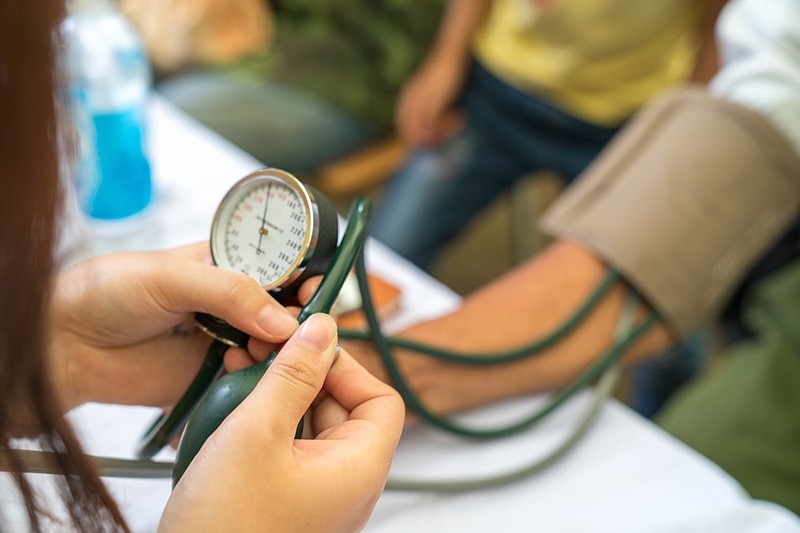 Nurse measuring blood pressure medical tile. / Getty Images/iStockphoto/vinhdav
