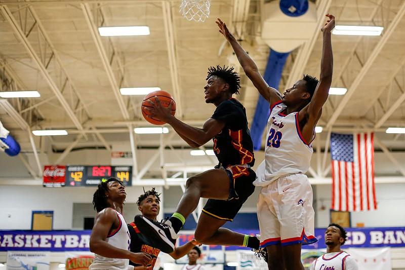 Staff photo by C.B. Schmelter / Howard's Jailen Sexton (2) goes up for a shot against Red Bank's Lekerrick Ellison (20) at Susan Ingram Thurman Gymnasium on the campus of Red Bank High School on Thursday, Jan. 9, 2020 in Red Bank, Tenn.