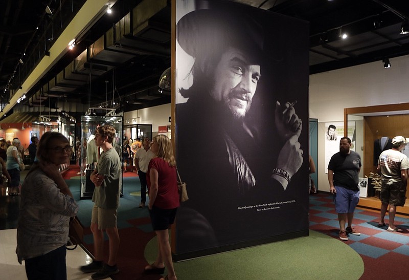 FILE - In this May 25, 2018 file photo, a portrait of Waylon Jennings is displayed as part of the Outlaws & Armadillos exhibit at the Country Music Hall of Fame and Museum in Nashville, Tenn. The Country Music Hall of Fame and Museum said nearly 1.3 million people visited the Nashville, Tennessee, museum last year, breaking an annual attendance record. (AP Photo/Mark Humphrey, File)


