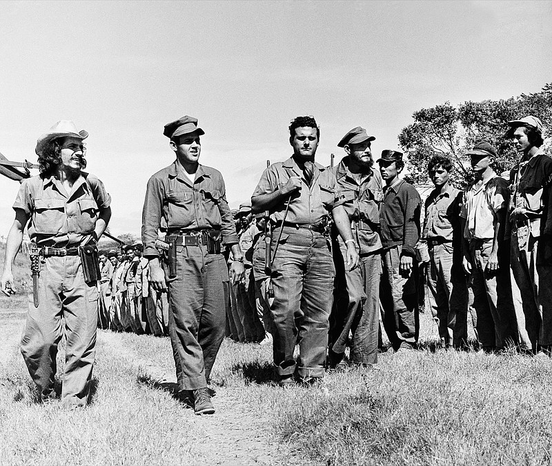 Officers inspect troop formation Jan. 11, 1959, Santiago de Cuba, Cuba. The four officers are, from left to right, Capt. Armando Torre, Lt. Armando Valdes, training officers, Capt. Frank Fiorini, AKA Frank Sturgis, U.S. citizen of Norfolk, Va., and Capt. Luis Lara, commanding officer of training camp. (AP Photo/RT)