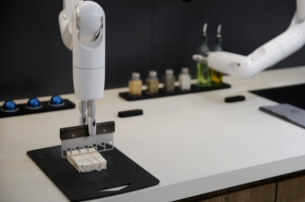 The Bot Chef cooking robot cuts tofu during a demonstration at the Samsung booth during the CES tech show, Tuesday, Jan. 7, 2020, in Las Vegas. The robot is designed to help with cooking tasks, not to make a meal all on it's own. (AP Photo/John Locher)