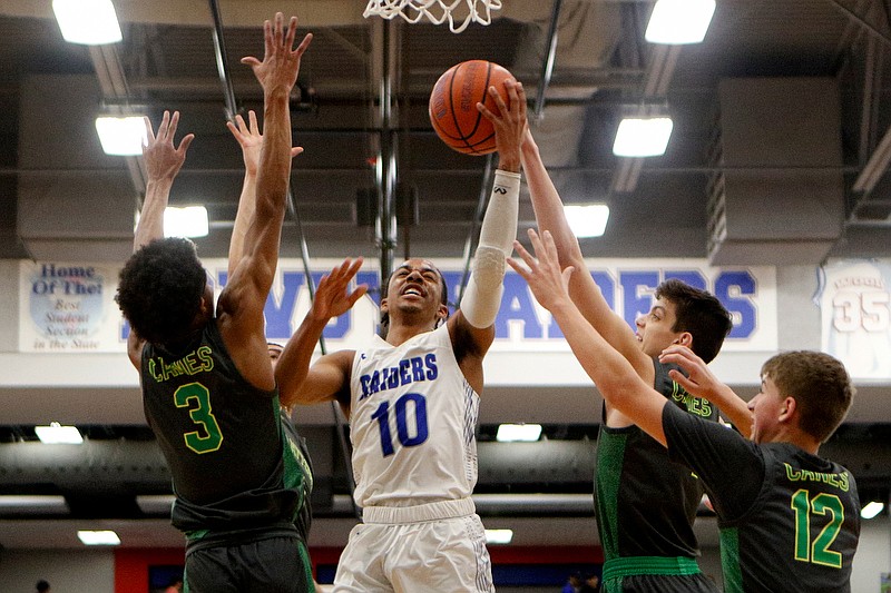 Staff photo by C.B. Schmelter / Cleveland's JaCobi Wood (10) goes up amid a trio of East Hamilton defenders at Cleveland High School's Raider Arena on Friday, Jan. 10, 2020 in Cleveland, Tenn.