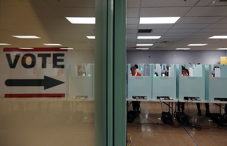 In this Nov. 6, 2018, file photo, people vote at a polling place in Las Vegas. State election officials in at least two dozen states, including Nevada, have seen suspicious cyber activity in the first half of January 2020, although it's unclear who was behind the efforts and no major problems were reported. (AP Photo/John Locher, File)