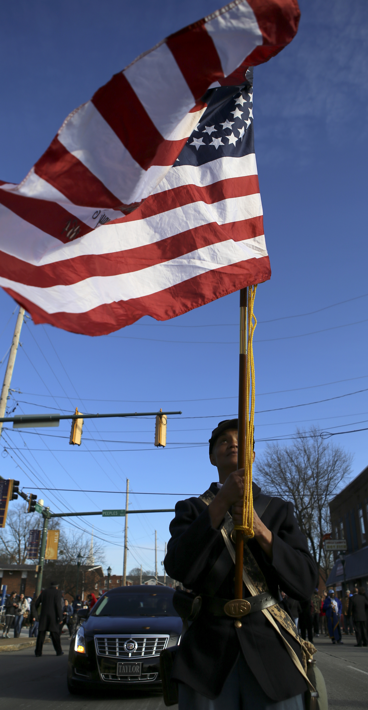 Joyce Allgood bears the flag for the 44th United States Colored Troops as a memorial parade and march along M.L. King Boulevard prepares to start on Monday, Jan. 15, 2018 in Chattanooga, Tenn. The memorial parade and march was part of the Unity Group of Chattanooga's 48th annual Martin Luther King Jr. Week celebration, which began on Jan. 8th and ended on Martin Luther King Jr. Day.