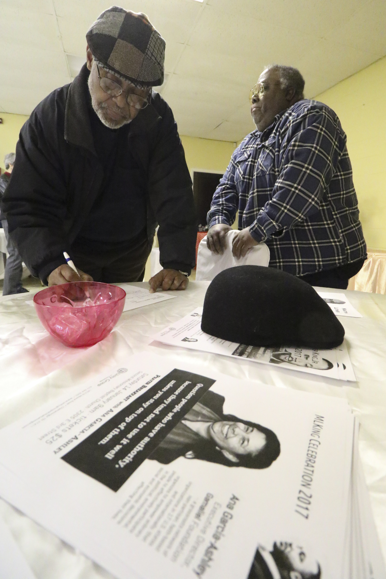 Staff Photo by Dan Henry / The Chattanooga Times Free Press- 1/8/17. Henry Slayton, left, signs in as Sherman Matthews prepares to lead the Unity Group Meeting while at Eastdale Village Community Methodist Church on Sunday, January 8, 2017.