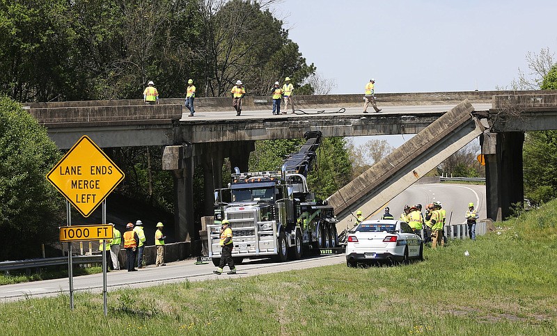 Staff file photo by Erin O. Smith / Tennessee Department of Transportation employees work to remove the concrete railing that fell from the Interstate 75 South ramp to I-75 South onto the I-75 North to I-24 West ramp on April 1, 2019. The site in Chattanooga is part of the infamous I-75/I-24 interchange known as "The Split," currently the subject of a $132.5 million improvement project that replaces bridges, add lanes and reduces the sharpness of curves.