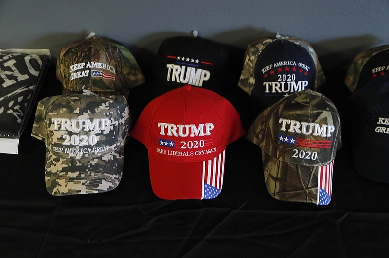 This Wednesday, Jan. 8, 2020 photo shows a display of President Trump baseball caps at the Bedford Trump Train headquarters in Temperance, Mich. The canvassing group in a township in Monroe County, is working to get out the vote for Trump. (AP Photo/Carlos Osorio)