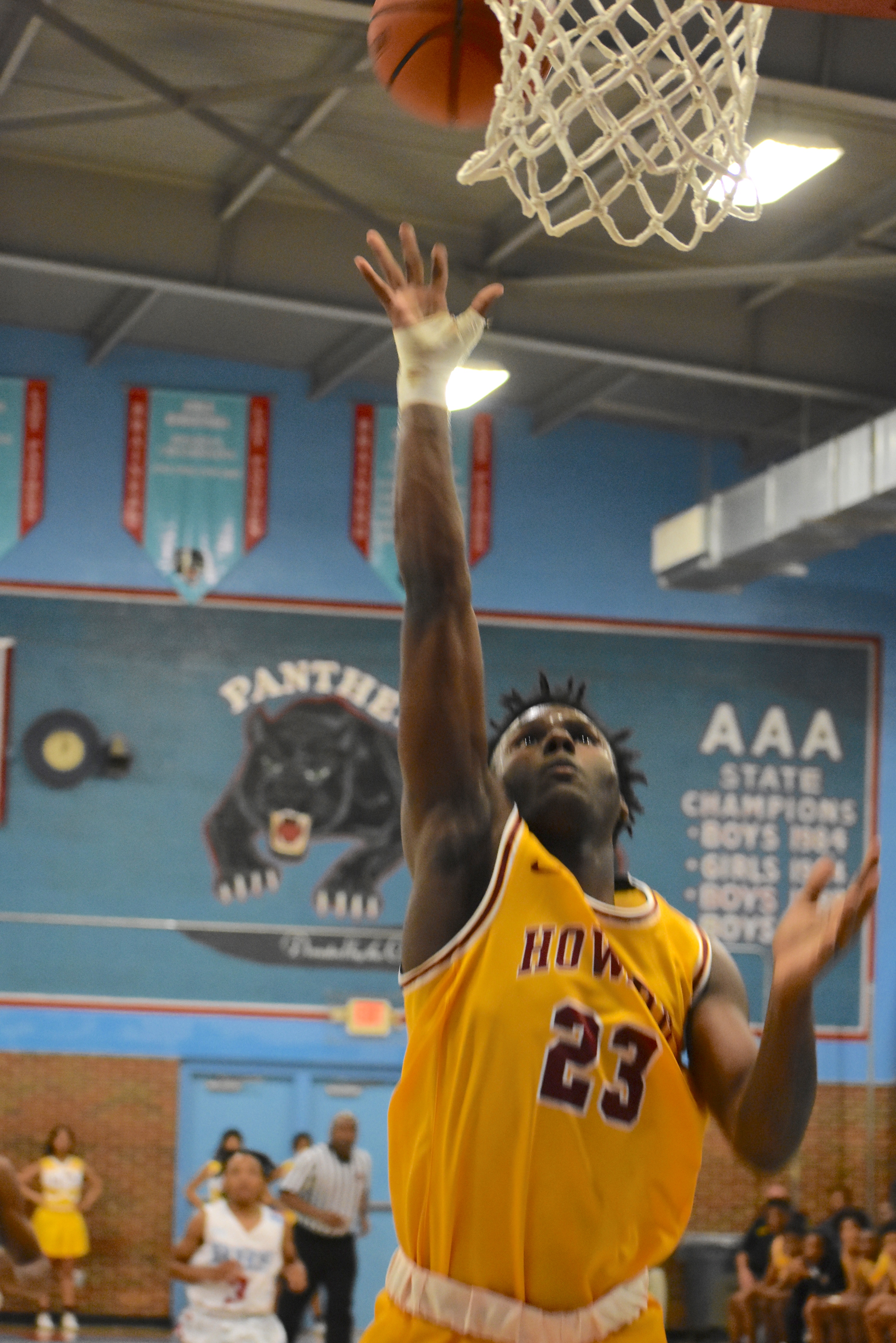 Howard senior CJ James follows his shot during Saturday's district road win over Brainerd. James finished with a game-high 19 points. /Staff photo by Patrick MacCoon