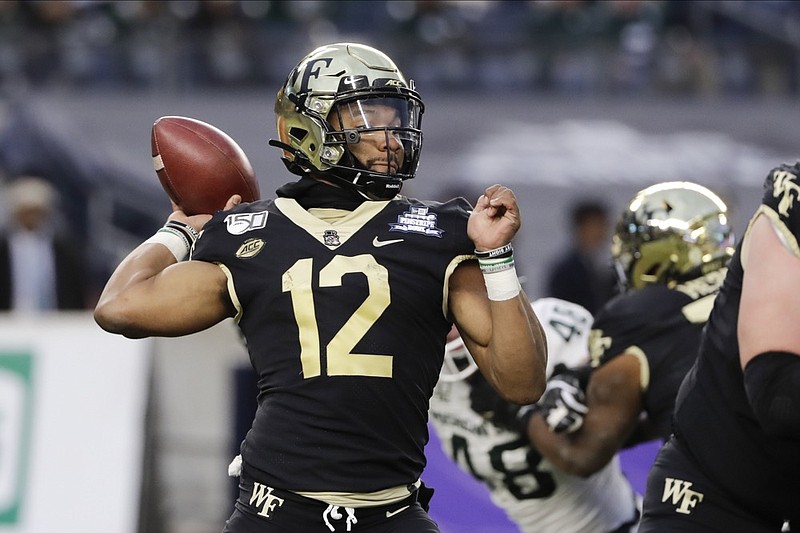Wake Forest's Jamie Newman (12) throws a pass during the first half of the Pinstripe Bowl NCAA college football game against Michigan State, Friday, Dec. 27, 2019, in New York. (AP Photo/Frank Franklin II)


