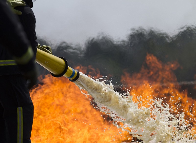 Fire-fighters applying foam to a fire. firefighting foam tile / Getty Images
