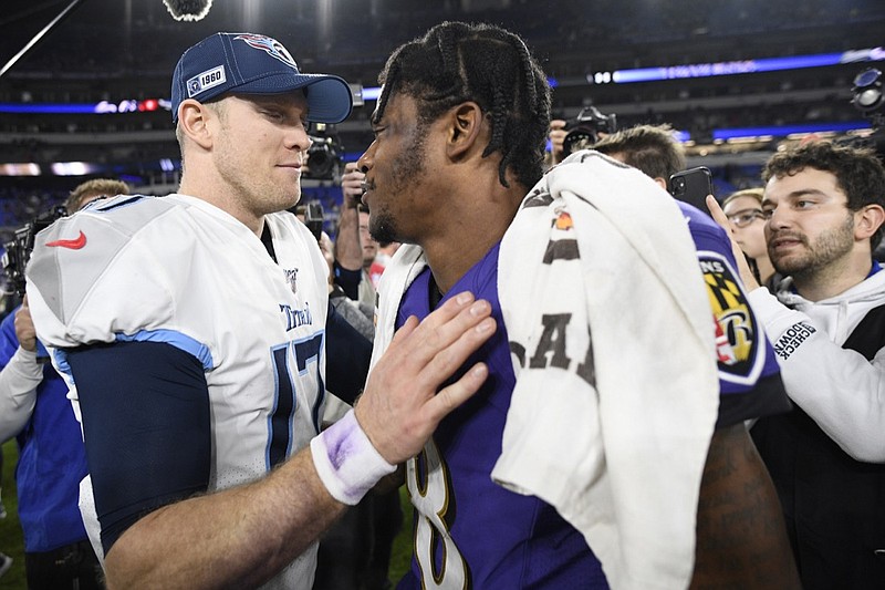 Tennessee Titans quarterback Ryan Tannehill, left, speaks with Baltimore Ravens quarterback Lamar Jackson after an NFL divisional playoff football game, Saturday, Jan. 11, 2020, in Baltimore. The Titans won 28-12. (AP Photo/Nick Wass)