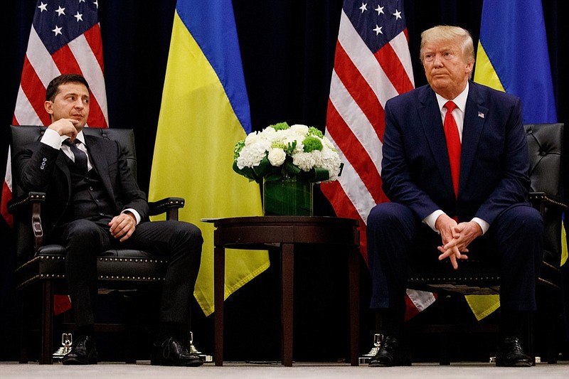 FILE - In this Sept. 25, 2019 file photo, President Donald Trump meets with Ukrainian President Volodymyr Zelenskiy in New York during the United Nations General Assembly. Trump's demand that Ukraine look into its own purported interference in the 2016 U.S. election and investigate a political rival, former Vice President Joe Biden, while the U.S. withheld the aid is at the heart of the congressional investigation that produced Trump's impeachment in the House on charges of abuse of power and obstruction of Congress. (AP Photo/Evan Vucci, File)
