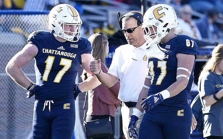 UTC head coach Rusty Wright confers with Chris James (17) and Jack Keebler (87). The University of Tennessee at Chattanooga Mocs hosted The Citadel Bulldogs in Southern Conference football at Finley Stadium on Nov. 16, 2019. / Staff Photo by Robin Rudd