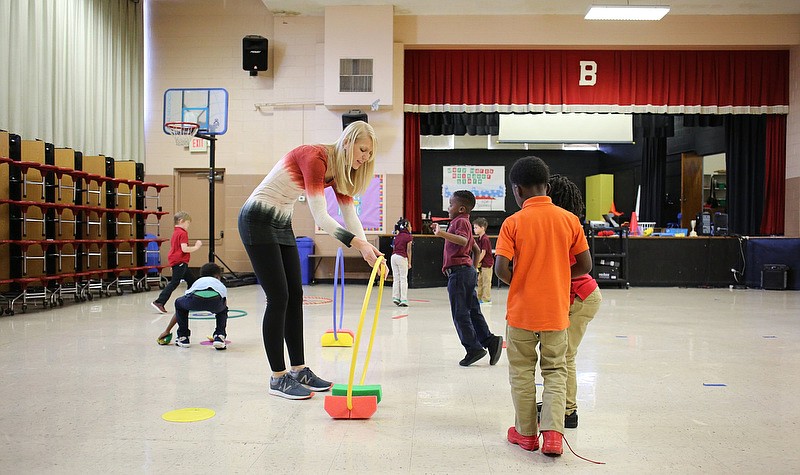Staff photo by Erin O. Smith / Amy Slagle, the physical education teacher at Barger Academy, works with students in the cafeteria at Barger Academy Thursday, December 5, 2019 in Chattanooga, Tennessee. The cafeteria also serves as the gym and auditorium. 