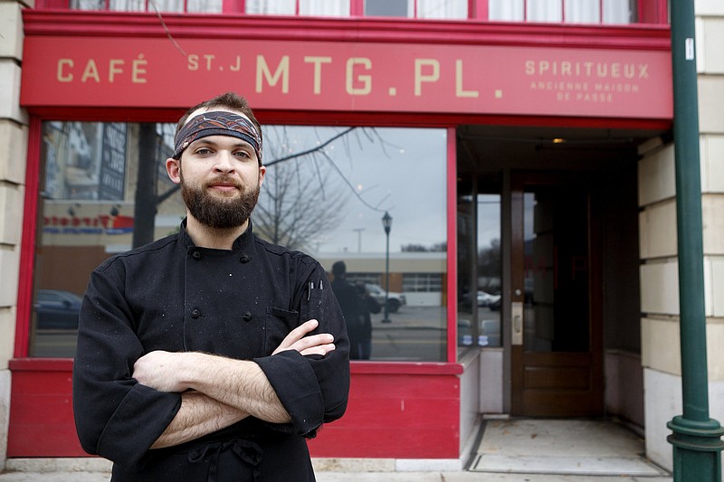 Staff photo by C.B. Schmelter / Sous chef Micah Adams stands outside St. John's Meeting Place.