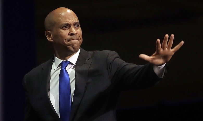 In this June 1, 2019, file photo, Democratic presidential candidate Sen. Cory Booker, of New Jersey, waves before speaking during the 2019 California Democratic Party State Organizing Convention in San Francisco. Booker has dropped out of the presidential race after failing to qualify for the December primary debate. (AP Photo/Jeff Chiu)