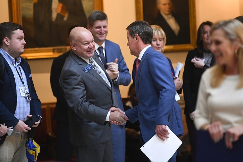 State Sen. Mike Dugan, R-Carrollton, second from left, shakes hands with Gov. Brian Kemp on the rotunda during the opening day of the year for the general session of the state legislature, Monday, Jan 13, 2020 in Atlanta. (AP Photo/John Amis)