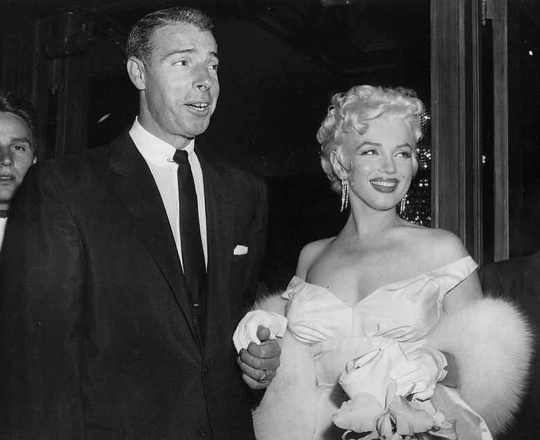 FILE - In this June 2, 1955 file photo, actress Marilyn Monroe, right, dressed in a glamorous evening gown, arrives with Joe DiMaggio at the theater. DiMaggio's love letter to Marilyn Monroe has sold for $78,125 at a Beverly Hills auction. Julien's Auctions in Beverly Hills says the letter, written by the baseball great after Monroe announced she was divorcing him, was sold Saturday, Dec. 6, 2014, to an undisclosed buyer. (AP Photo, File)