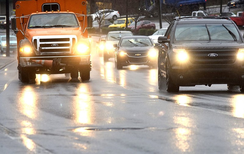Staff Photo by Robin Rudd/ The headlights of inbound traffic glare off the wet pavement of Brainerd Road, just east of the intersection of Tunnel Boulevard on the morning of Tuesday, Jan. 14, 2020. 
