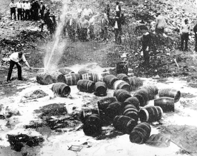 FILE - In this June 18, 1931, file photo beer barrels are destroyed by prohibition agents at a dump in New York City. The federal government, as well as state and local authorities, spent huge sums on enforcement yet never allocated sufficient resources to do the job effectively. Bootleggers awash in cash bribed judges, politicians and law enforcement officers to let their operations continue. (AP Photo, File)