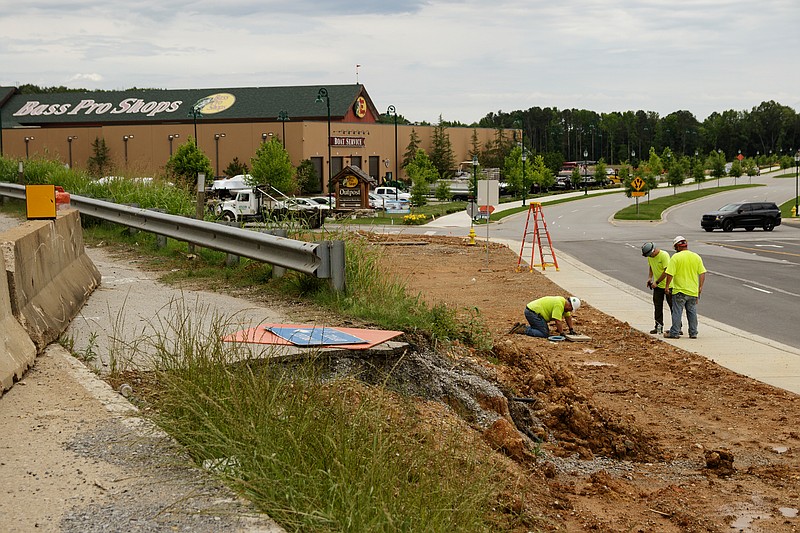 A construction crew works on Camp Jordan Parkway near Interstate-75 and Exit 1 at the Jordan Crossing shopping center. / Staff file photo by Doug Strickland