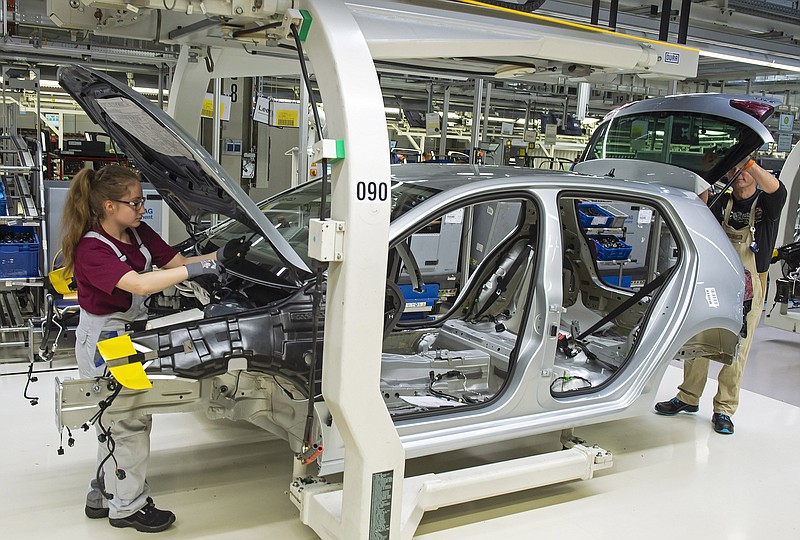 File—- Picture taken May 14, 2019 shows complete Golf car bodies at the assembly line during a press tour of the plant of the German manufacturer Volkswagen AG (VW) in Zwickau, Germany. The first ID. production electrical vehicles are to roll off the assembly line at the end of 2019. Only e-cars will be built at Zwickau in 2021. (AP Photo/Jens Meyer)