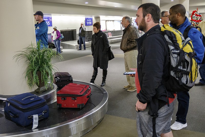 Staff file photo / Travelers wait at baggage claim at Chattanooga Airport.