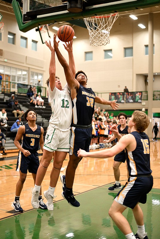 Staff Photo by Robin Rudd / East Hamilton's Haynes Eller (12) and Walker Valley's Shimier Davis (32) vie for a rebound. The East Hamilton Hurricanes hosted the Walker Valley Mustangs in TSSAA boys basketball on January 14, 2020.