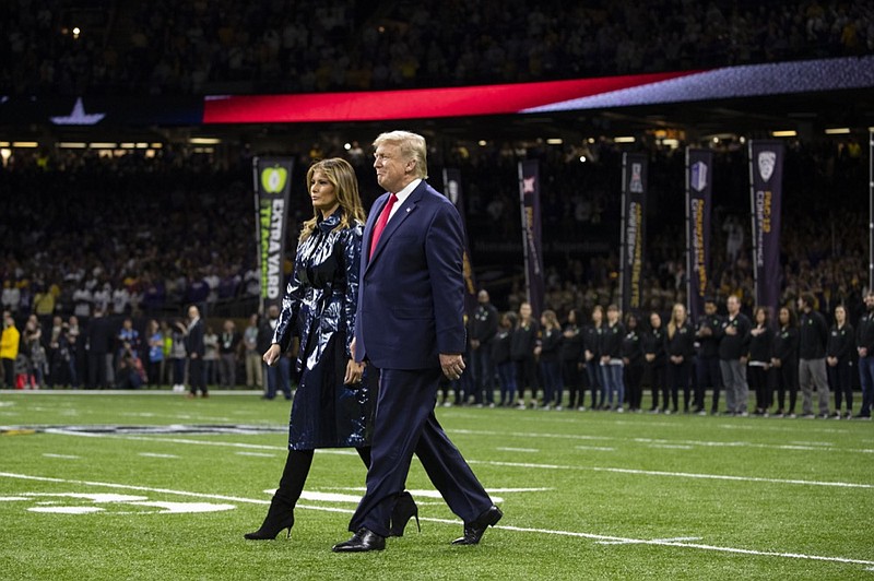 President Donald Trump and first lady Melania Trump arrive for the College Football Playoff National Championship game between LSU and Clemson, Monday, Jan. 13, 2020, in New Orleans. (AP Photo/ Evan Vucci)

