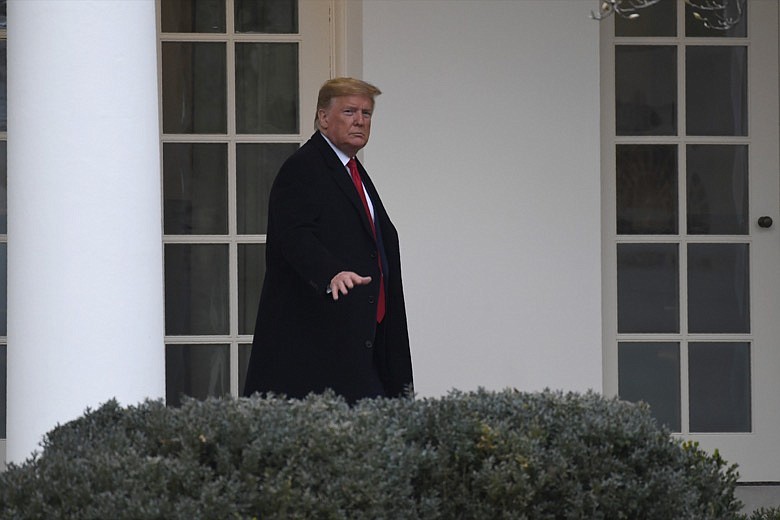 President Donald Trump walks along the colonnade of the White House in Washington, Monday, Jan. 13, 2020. A U.S. cybersecurity company says Russian military agents successfully hacked the Ukrainian gas company at the center of the scandal that led to President Donald Trump's impeachment. (AP Photo/Susan Walsh)