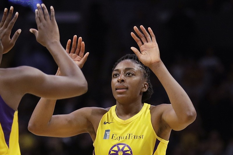 FILE - In this Friday, May 31, 2019, file photo, Los Angeles Sparks' Chiney Ogwumike (13), obscured at left, and her sister Nneka Ogwumike celebrate after a win over the Connecticut Sun in a WNBA basketball game in Los Angeles. The WNBA and its union announced a tentative eight-year labor deal Tuesday, Jan. 14, 2020, that will allow top players to earn more than $500,000 while the average annual compensation for players will surpass six figures for the first time. "It was collaborative effort,'" WNBA players' union president Nneka Ogwumike said. (AP Photo/Marcio Jose Sanchez, File)


