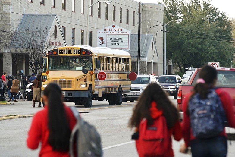 Students watch from across the street as authorities respond to a shooting at Bellaire High School in Bellaire, Texas, Tuesday, Jan. 14, 2020. (Mark Mulligan/Houston Chronicle via AP)