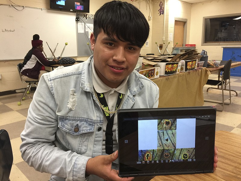 Photo by Mark Kennedy/  Amilcar Vargas-Lucas, of the Howard School, shows off his winning artwork.