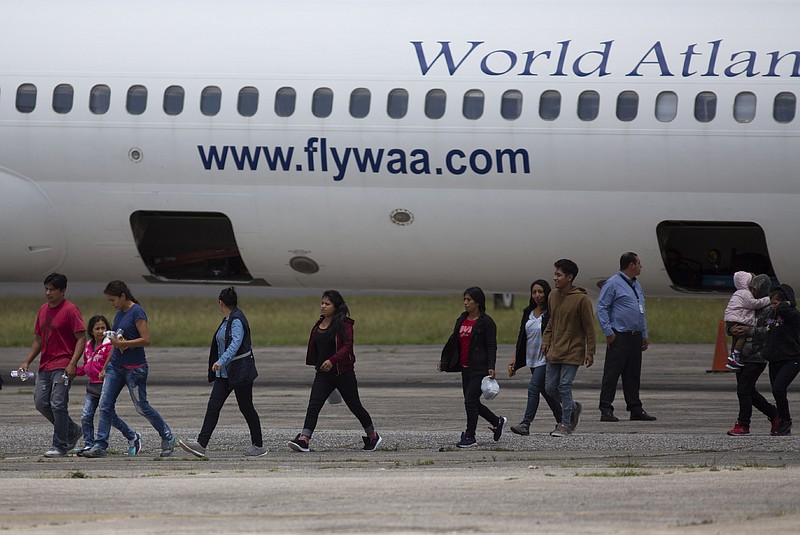 FILE - In this Aug. 20, 2019, file photo, Guatemalans who were deported from the United States arrive to La Aurora International airport in Guatemala City. A federal lawsuit filed Wednesday argues that Trump administration asylum agreements with Guatemala, El Salvador and Honduras are illegal. The agreements allow U.S. immigration officials to send asylum seekers to the Central American nations. The American Civil Liberties lawsuit says the agreements are dangerous and violate the historic role of the U.S. as a humanitarian nation. The American Civil Liberties Union and other civil rights groups want the so-called cooperative asylum agreements declared illegal, and are asking a federal judge to block Homeland Security officials from enforcing the new rules. (AP Photo/Moises Castillo, File)