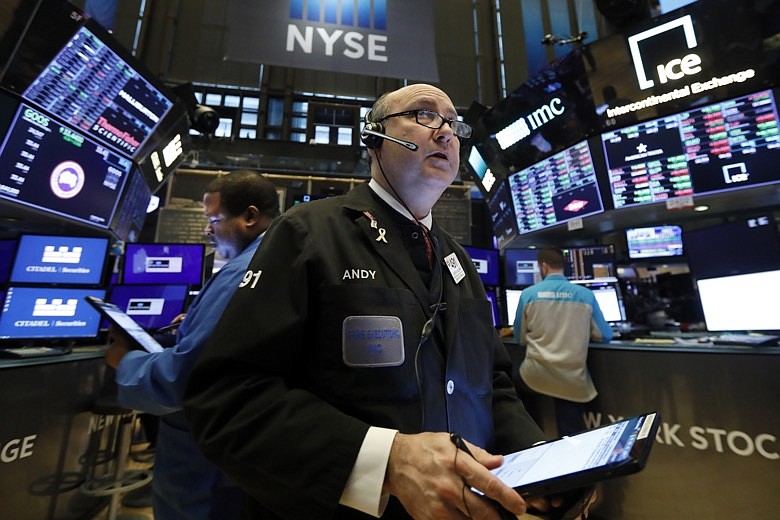 In this Jan. 10, 2020, file photo trader Andrew Silverman works on the floor of the New York Stock Exchange. The U.S. stock market opens at 9:30 a.m. EST on Wednesday, Jan. 15. (AP Photo/Richard Drew)