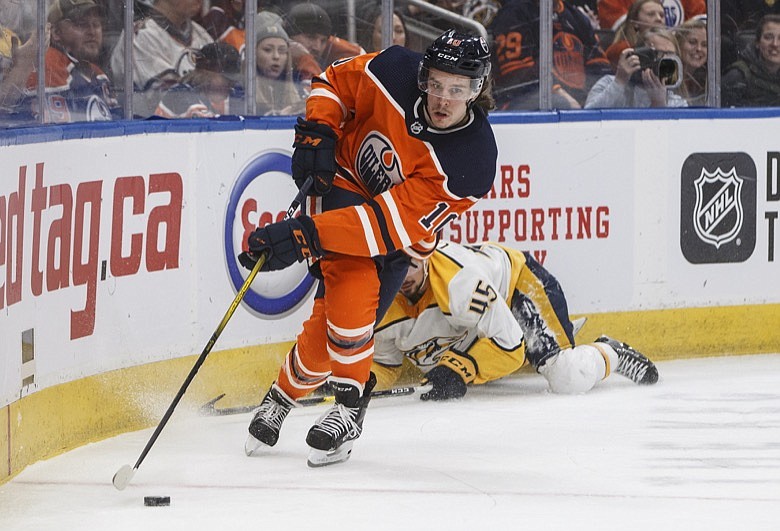 Nashville Predators' Alexandre Carrier (45) is tripped up as Edmonton Oilers' Joakim Nygard (10) carries the puck during second period NHL hockey action in Edmonton, Alberta, Tuesday, Jan. 14, 2019. (Jason Franson/The Canadian Press via AP)