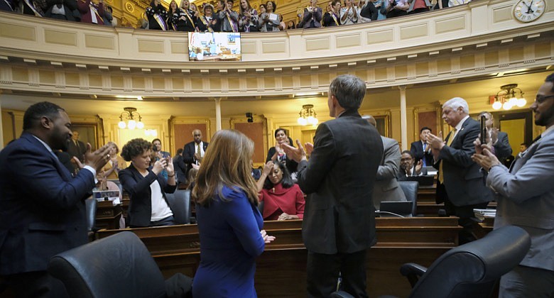 Del. Jennifer Carroll Foy, D-Prince William, seated center, is applauded by fellow members and Equal Rights Amendment supporters in the House of Delegates gallery after she spoke for passage of the ERA resolution she sponsored, Wednesday, Jan. 15, 2020, at the state Capitol in Richmond, Va. (Bob Brown/Richmond Times-Dispatch via AP)