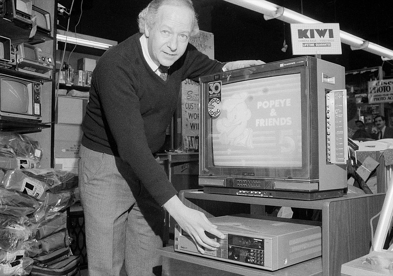 Mel Tillman, manager of S&S Sound City, in New York, demonstrates how a television program is taped with a Toshiba video cassette recorder (VCR), Jan. 17, 1984. The U.S. Supreme Court ruled it is legal to tape television programs for personal enjoyment. (AP Photo/Suzanne Vlamis)

