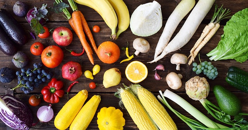 White, yellow, green, orange, red, purple fruits and vegetables on wooden background. Healthy food. Multicolored raw food tile rainbow food diet tile / Getty Images
