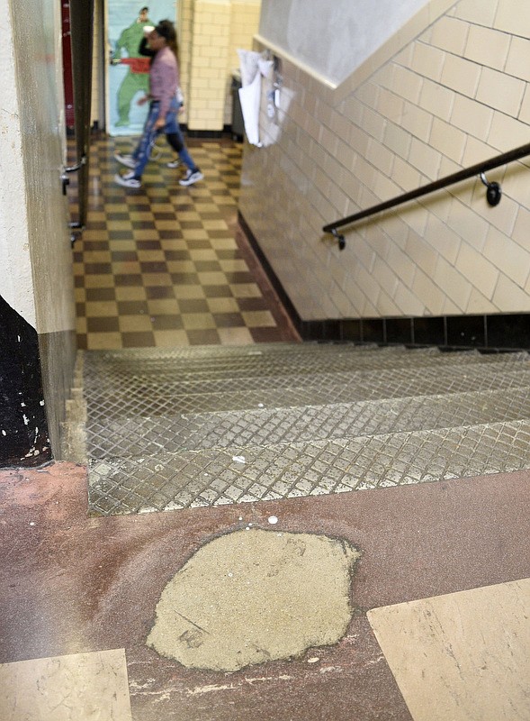 Staff Photo by Robin Rudd/ Years of students footsteps have worn the tile on a landing between floors at Tyner Academy. Tyner Academy Principal Gerald Harris gave the Times Free Press a tour of the school's facilities on December 6, 2019.