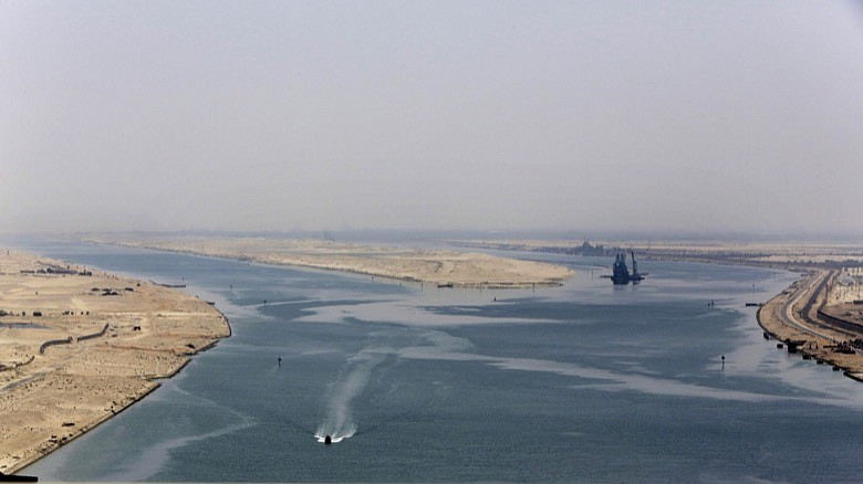 In this Aug. 6, 2015 file photo, an army zodiac secures the entrance of the new section of the Suez Canal in Ismailia, Egypt. The Suez Canal, which connects the Red Sea to the Mediterranean Sea, revolutionized maritime travel by creating a direct shipping route between the East and the West. But as Egypt marks the 150th anniversary of its opening, marine biologists are bemoaning one of the famed waterway's lesser known legacies, the invasion of hundreds of non-native species that have driven the native marine life toward extinction and altered the delicate Mediterranean ecosystem with potentially devastating consequences. (AP Photo/Amr Nabil, File)