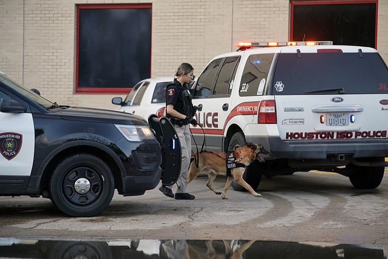 A Houston Independent School District Police K-9 unit responds to a shooting, Tuesday, Jan. 14, 2020, at Bellaire High School in Bellaire, Texas. (Mark Mulligan/Houston Chronicle via AP)