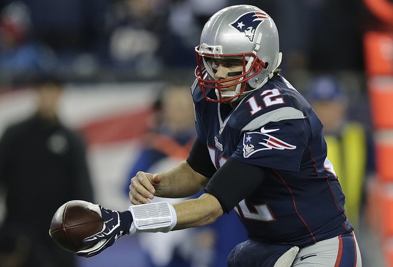 In this Sunday, Jan. 18, 2015, photo New England Patriots quarterback Tom Brady hands the ball off during the first half of the NFL football AFC Championship game against the Indianapolis Colts in Foxborough, Mass. The NFL says its investigation into whether the New England Patriots used underinflated footballs in the AFC championship game is ongoing after a report Tuesday night. Jan. 20, 2015, claimed the league found 11 balls were not properly inflated. (AP Photo/Charles Krupa)

