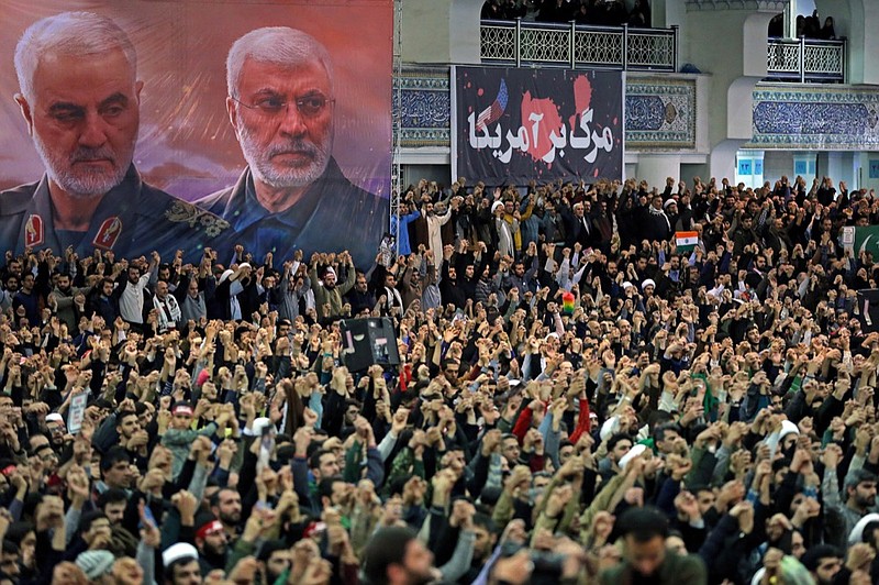 In this picture released by the official website of the office of the Iranian supreme leader, worshippers chant slogans during Friday prayers ceremony, as a banner show Iranian Revolutionary Guard Gen. Qassem Soleimani, left, and Iraqi Shiite senior militia commander Abu Mahdi al-Muhandis, who were killed in Iraq in a U.S. drone attack on Jan. 3, and a banner which reads in Persian: “Death To America, ”at Imam Khomeini Grand Mosque in Tehran, Iran, Friday, Jan. 17, 2020. Iran's supreme leader said in his sermons President Donald Trump is a "clown" who only pretends to support the Iranian people but will “push a poisonous dagger” into their backs, as he struck a defiant tone in his first Friday sermon in Tehran in eight years. (Office of the Iranian Supreme Leader via AP)