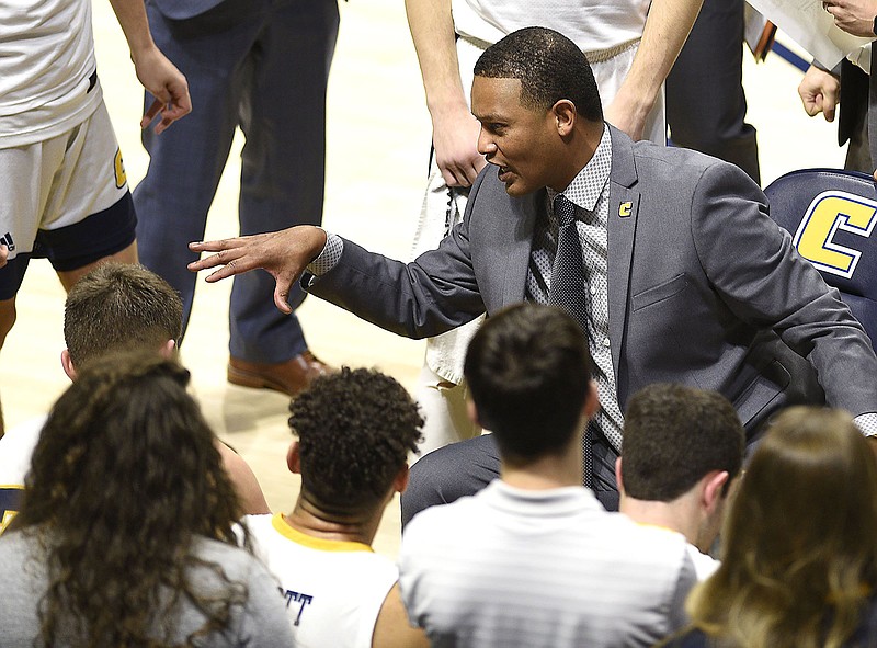 UTC men's basketball coach Lamont Paris talks to the Mocs during a timeout in Wednesday night's home game against Wofford. Paris takes pride in his teams playing with effort and energy, something he said the Mocs have done in back-to-back SoCon victories. / Staff photo by Robin Rudd