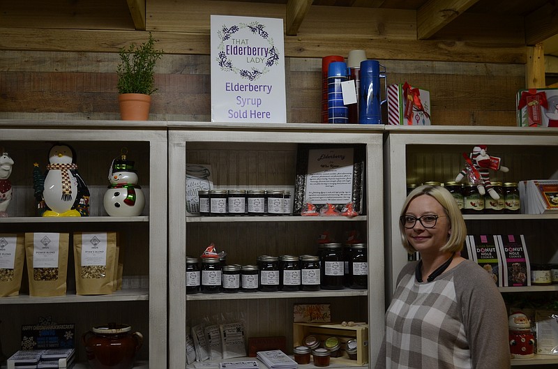 That Elderberry Lady owner Amanda Dillard stands with her display at Vinterest Southside. / Staff photo by Emily Crisman