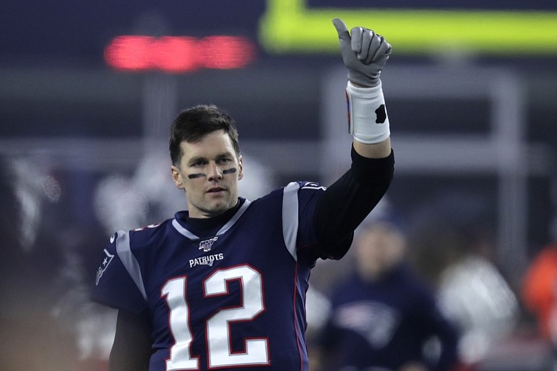 New England Patriots quarterback Tom Brady signals to a teammate before a wild-card playoff against the Tennessee Titans on Jan. 4. The Titans won in what was possibly Brady's final game of his long career with the Patriots. / AP photo by Charles Krupa

